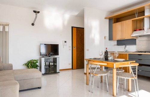 Ponte San Giovanni Apartment | Bright 80 sqm apartment that can accommodate up to 6 people, located near the Ponte San Giovanni station. It consists of a living room with kitchen and dining area, a bathroom and two bedrooms. The flat is located on the ninth floor and has a large terra