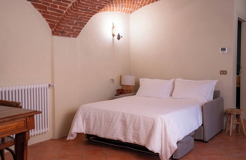 Lessona Bed & Breakfast | Bruno Selvago's Casba. Rustic house with exposed brick surrounded by vineyards.