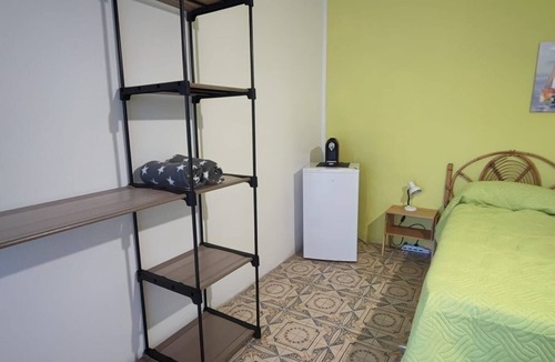 Stromboli Villa | Green room with 4 beds, bathroom and patio with equipped kitchen