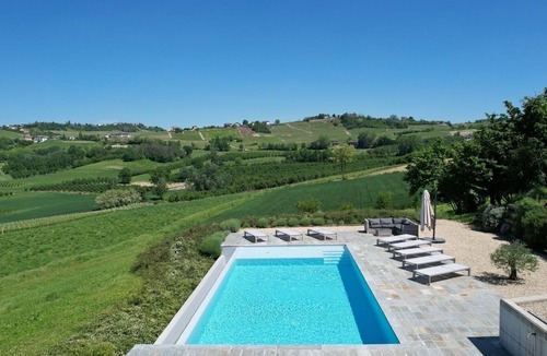 Castagnole delle Lanze Villa | Villa with vineyards, infinity pool, views of an UNESCO castle and the alps.